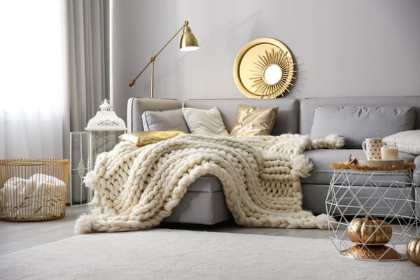 cozy home accessories with chunk knit blanket on the couch