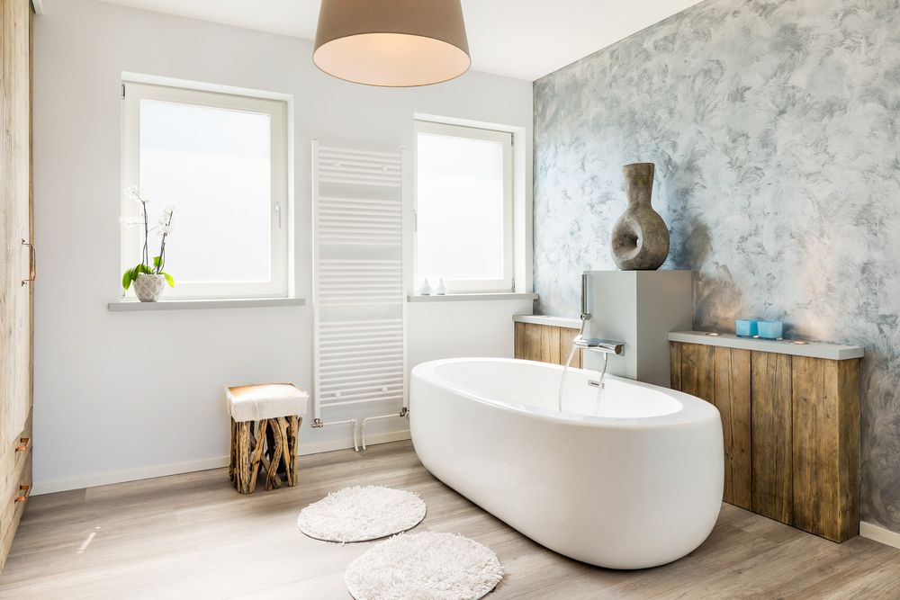 bathroom with freestanding tub and heated tower rack