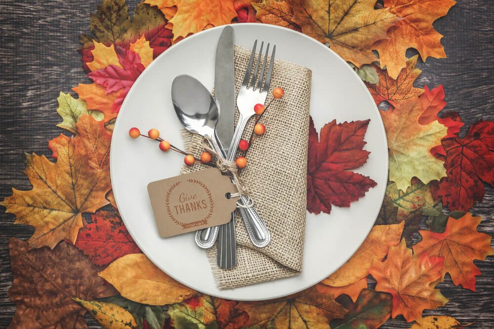 plate setting on a bed of dry leaves