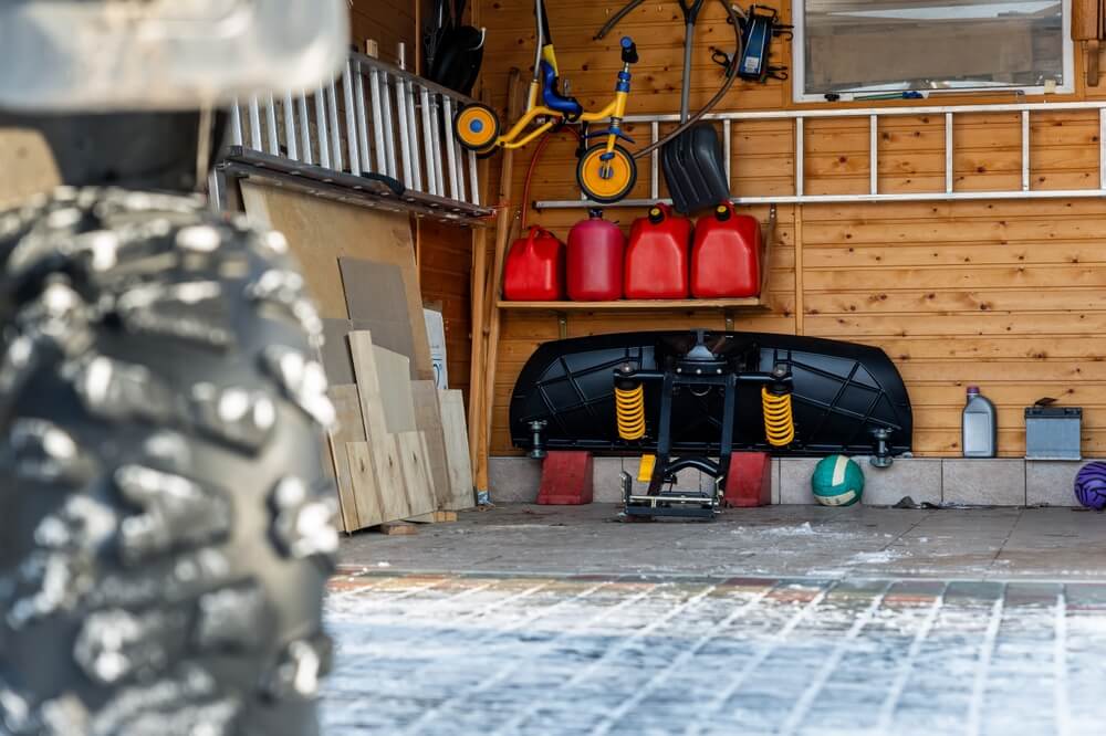 Ladders, plastic tanks and other itmes in a garage