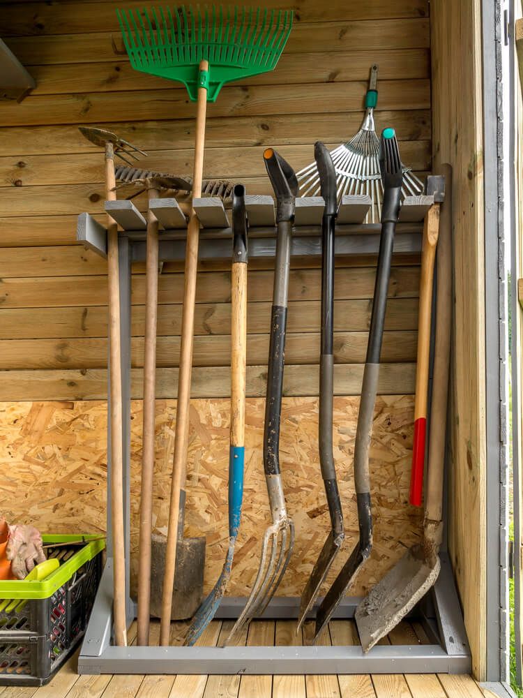 Garden tolls lined up against the wall