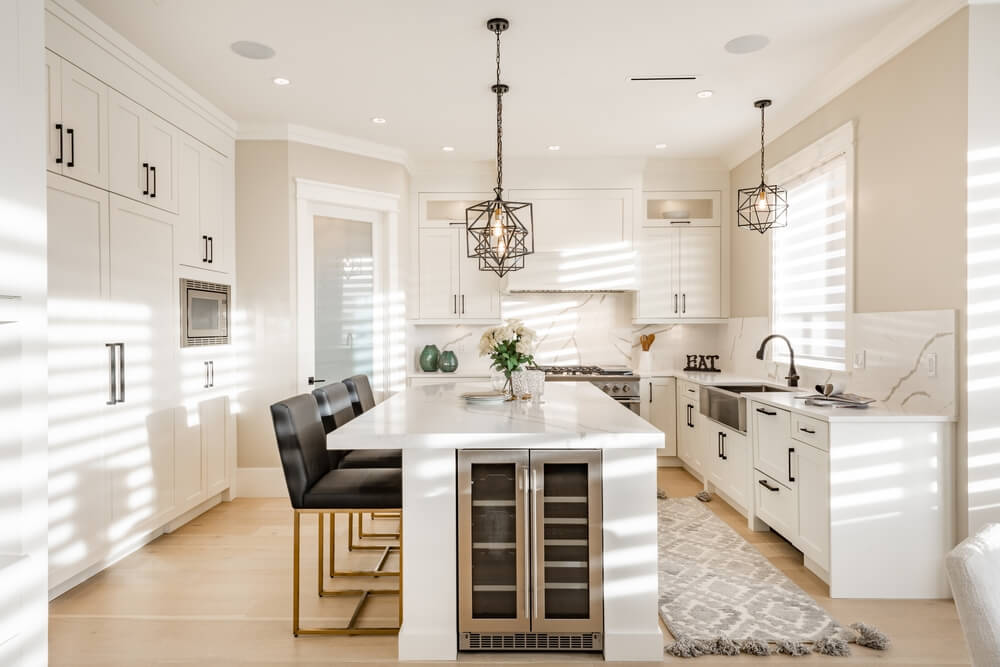 Warm white kitchen with wine fridge in the island