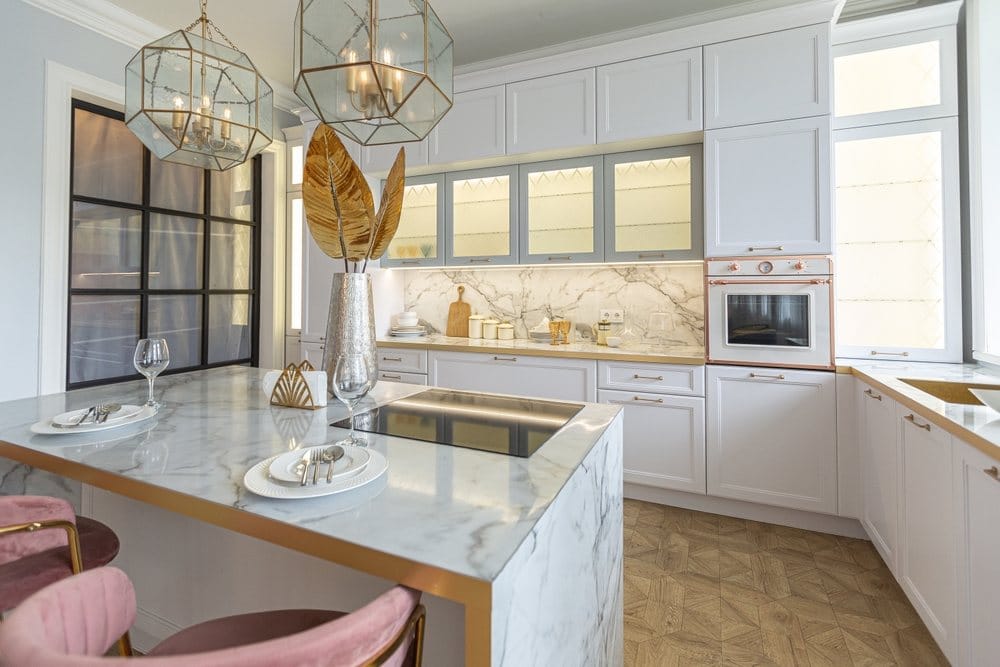 white stylish kitchen with a cooking island and paneled appliances