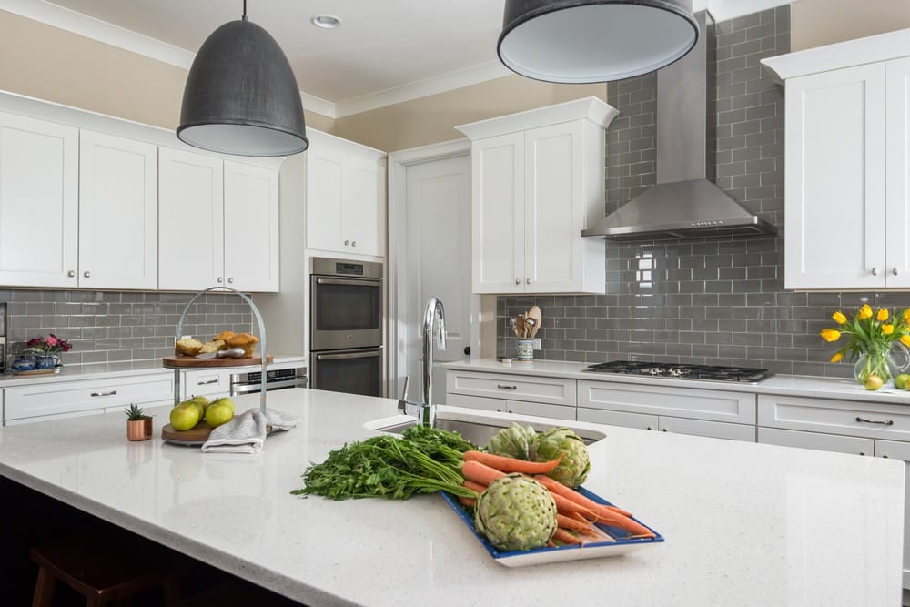 A white kitchen with white quartz counters